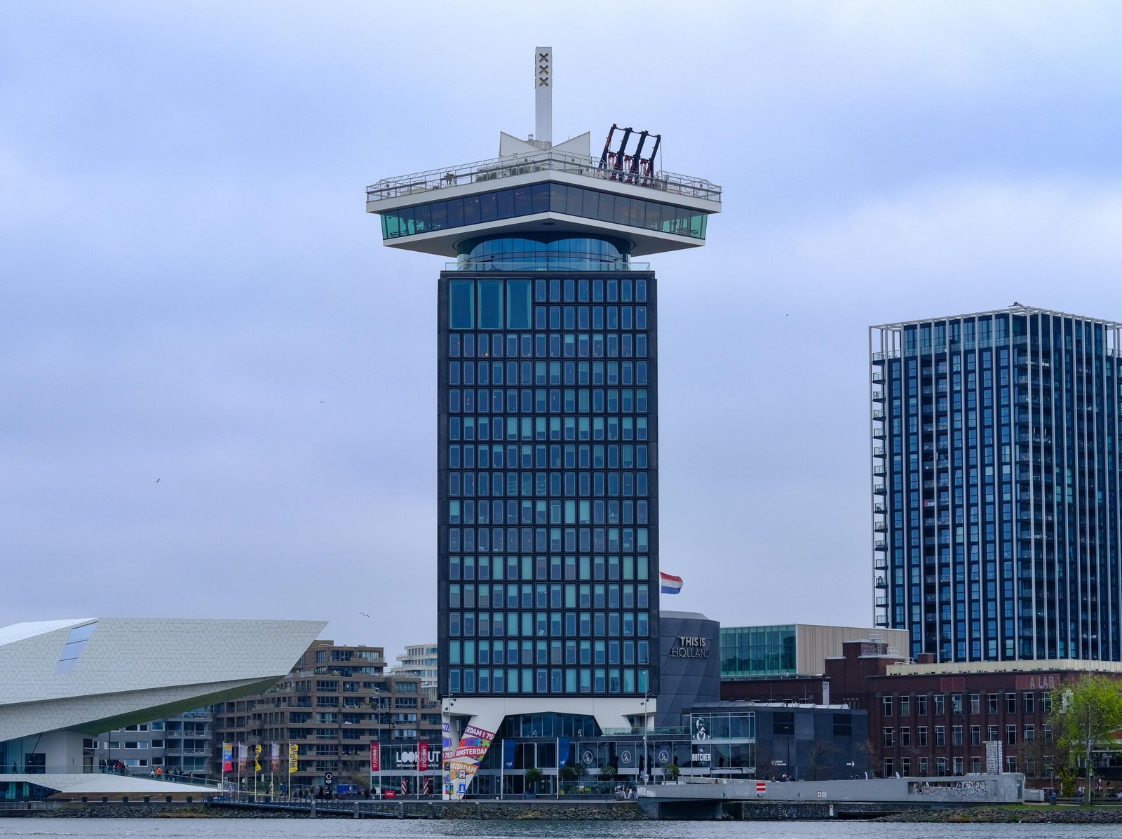 pexels-photo-31758700-31758700 Scenic view of the iconic A'dam Tower against a cloudy Amsterdam skyline.