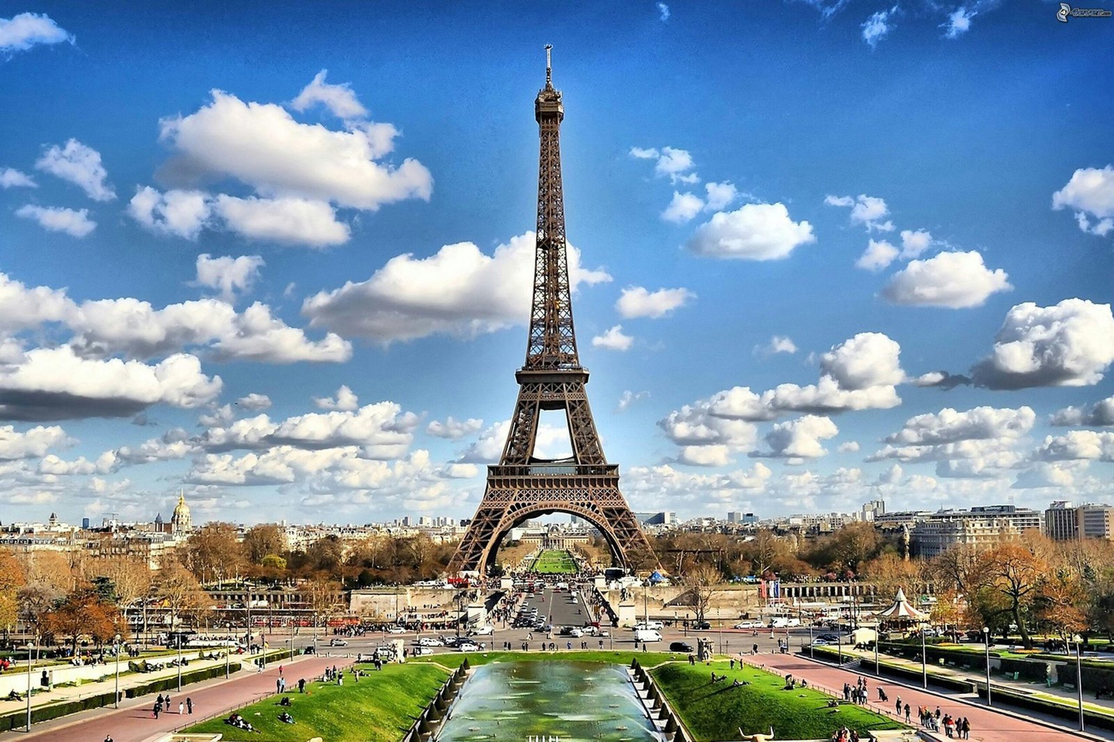 pexels-photo-338515-338515 Stunning view of the Eiffel Tower with a backdrop of fluffy clouds and blue sky in Paris.