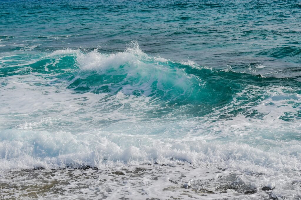 Vibrant ocean waves crashing onto the shore, showcasing the energy and serenity of the sea