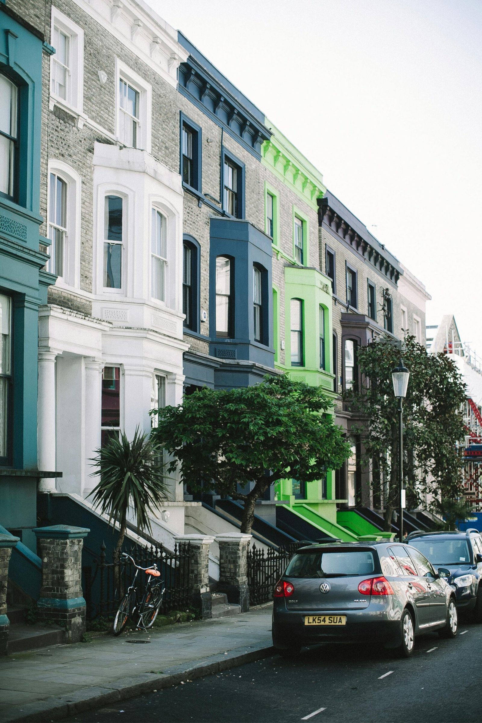 pexels-photo-3639539-3639539 Charming street view of colorful Victorian houses and parked cars in Notting Hill, London.