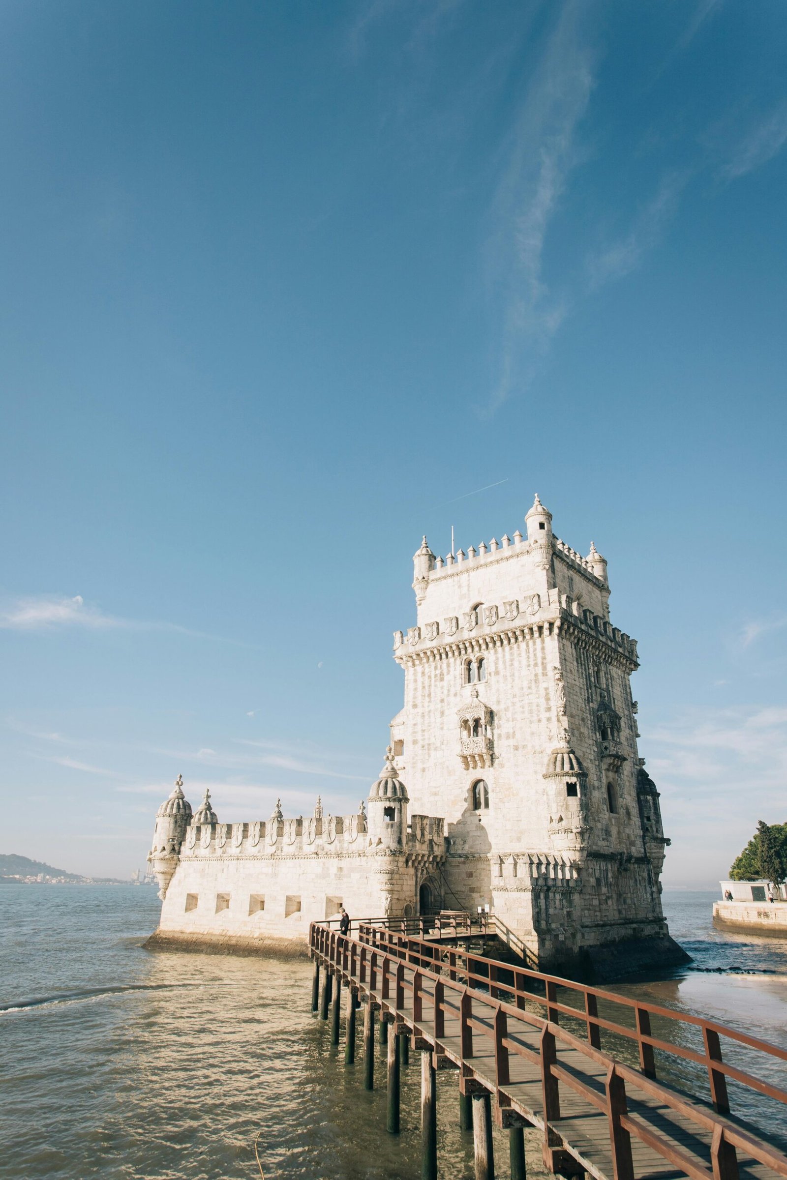 pexels-photo-3831829-3831829 Belem Tower in Lisbon, Portugal, under a clear sky with a scenic walkway.