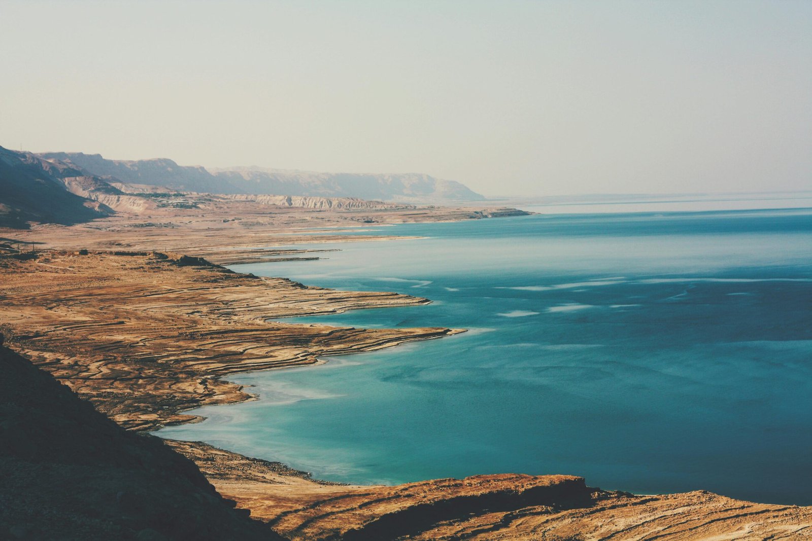 pexels-photo-3927155-3927155 A breathtaking aerial view of the Dead Sea's coastline, capturing its rugged beauty and serene blue waters.
