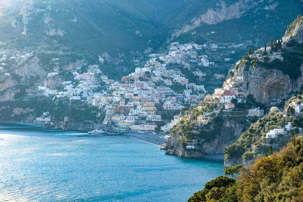 Stunning aerial view of the Amalfi Coast with colorful hillside buildings and turquoise sea.