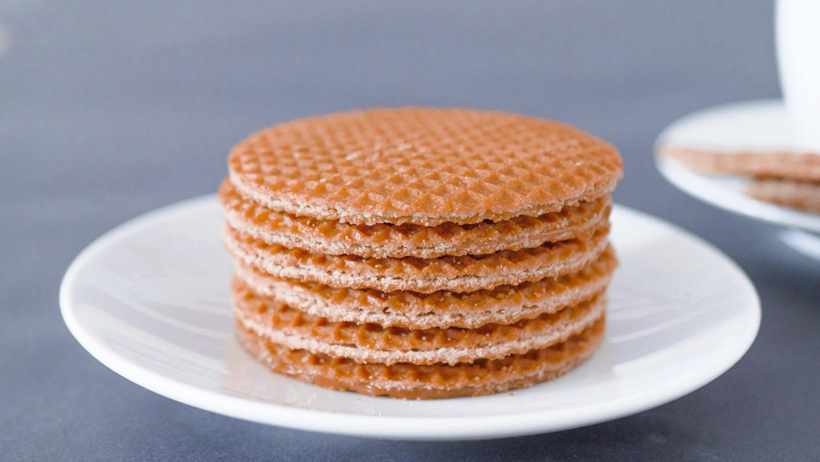 pexels-photo-6627265-6627265 Stack of tasty stroopwafels on a white plate, perfect for a sweet snack.