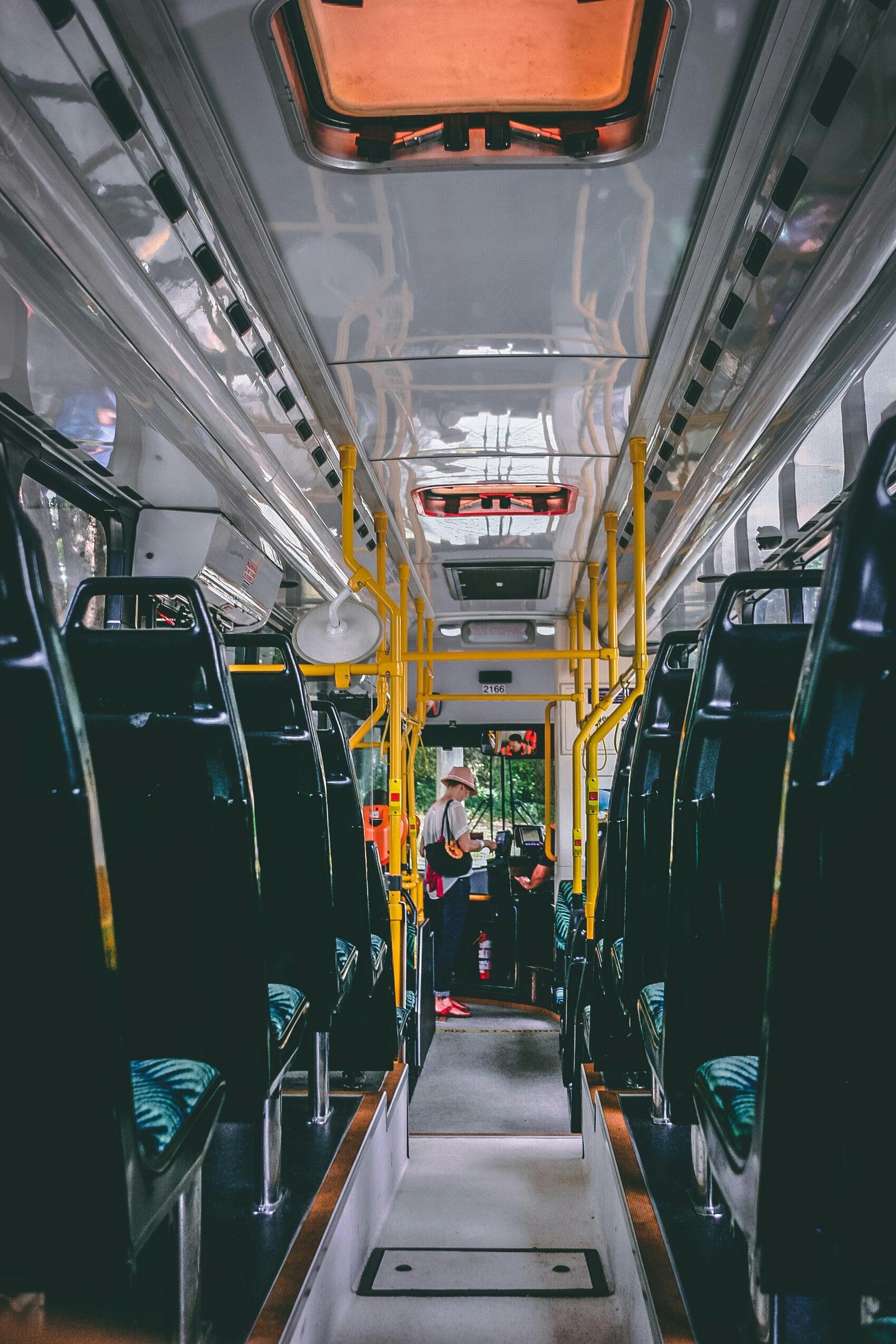 pexels-photo-946281-946281 View of a bright and modern public bus interior with passengers standing and sitting, emphasizing public transport.