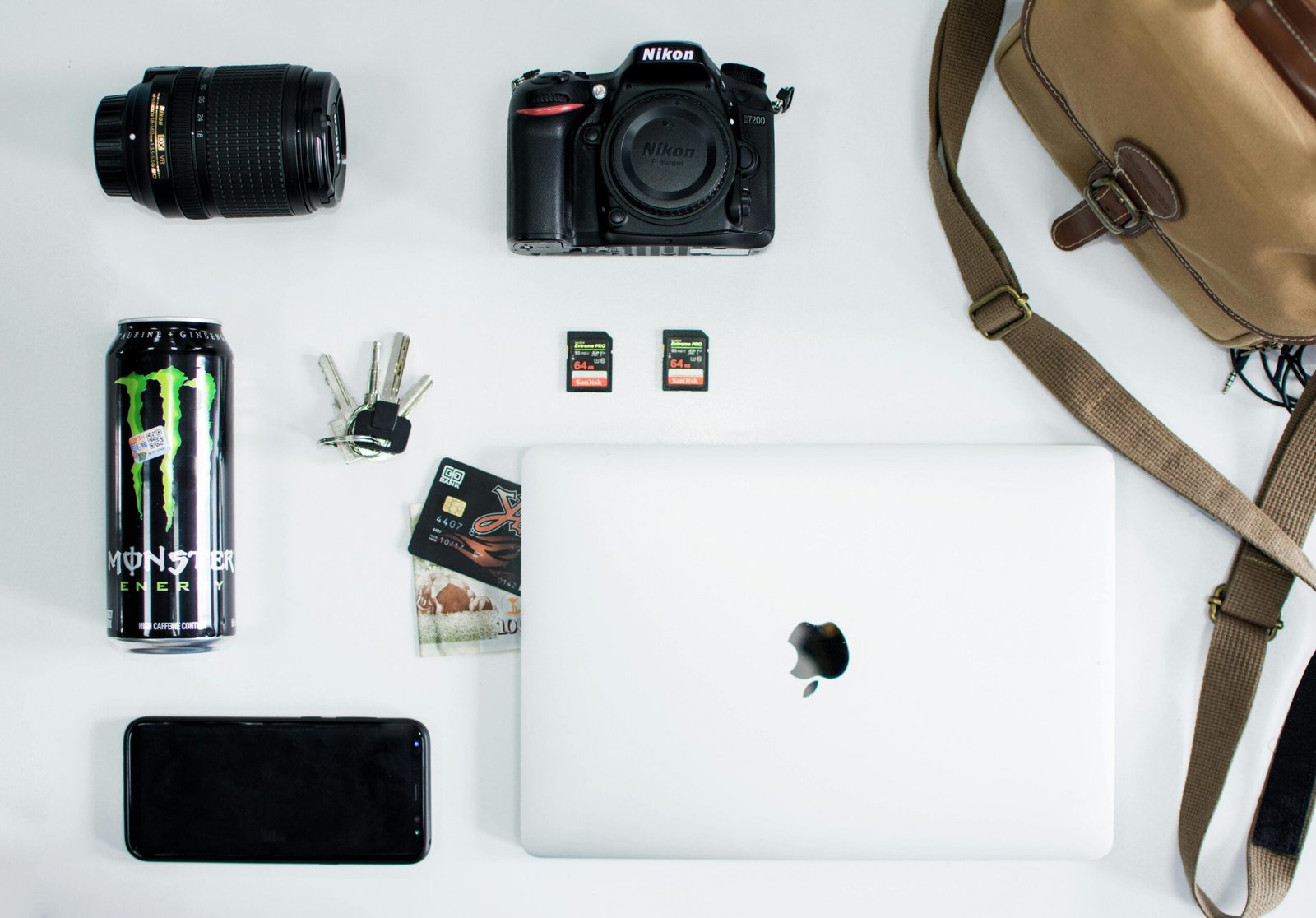 pexels-photo-999661-999661 Flat lay of camera, laptop, and tech essentials on a white surface, showcasing everyday items.
