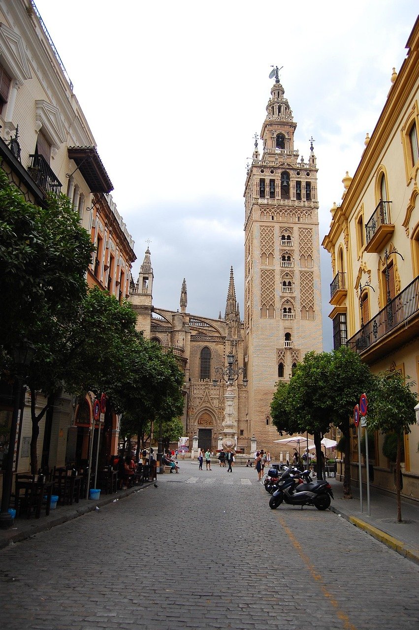 seville, andalusia, spain, highway, car wallpapers, via, cars, road, center, palms, clouds, nature, backlighting, trees, monument, giralda, cathedral, street, car, square, stone, cobble