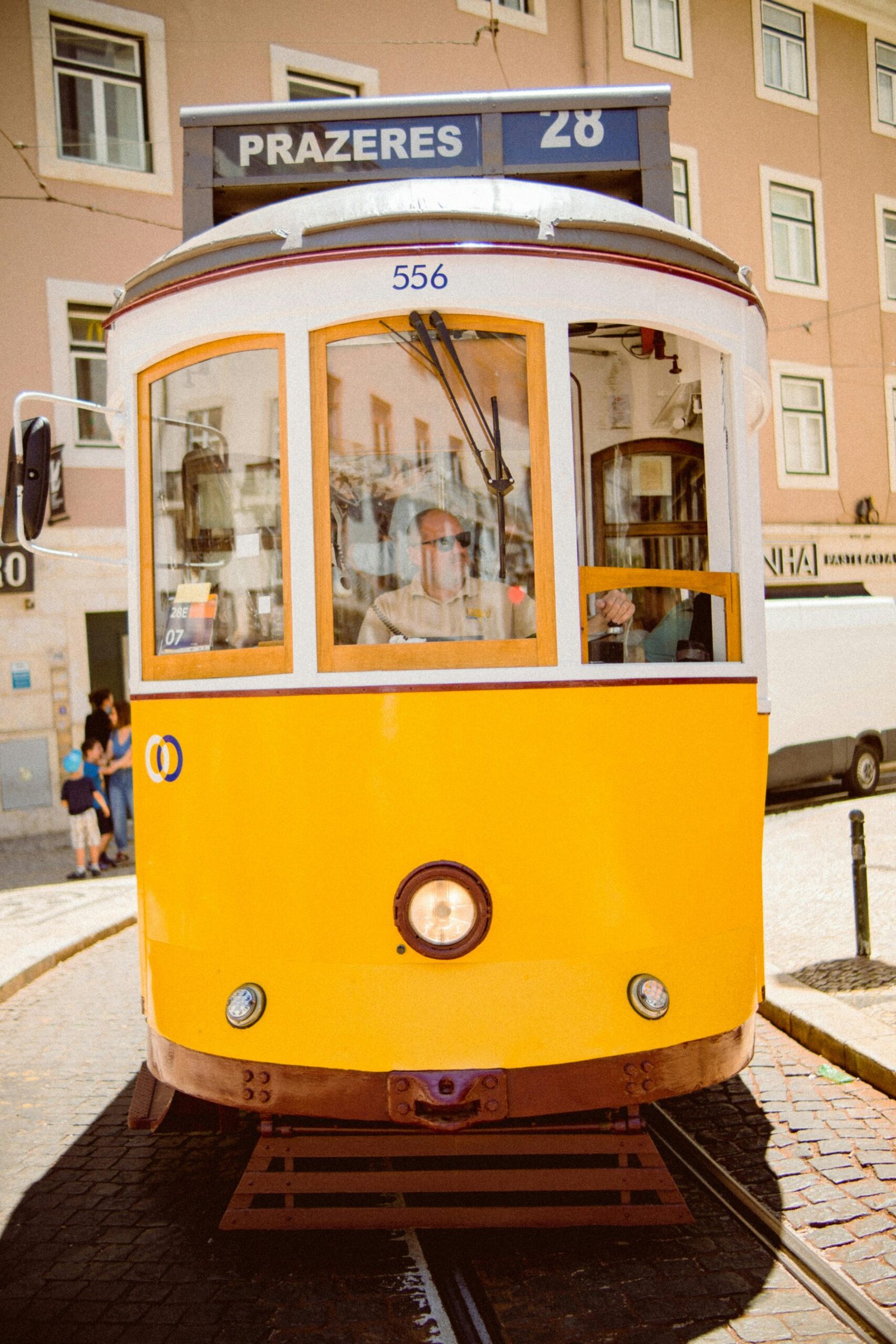 A classic yellow tram number 28 navigating through the charming streets of Lisbon, Portugal.