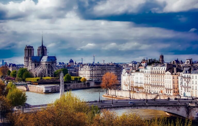 A beautiful view of the Notre Dame Cathedral and Paris skyline over the River Seine.