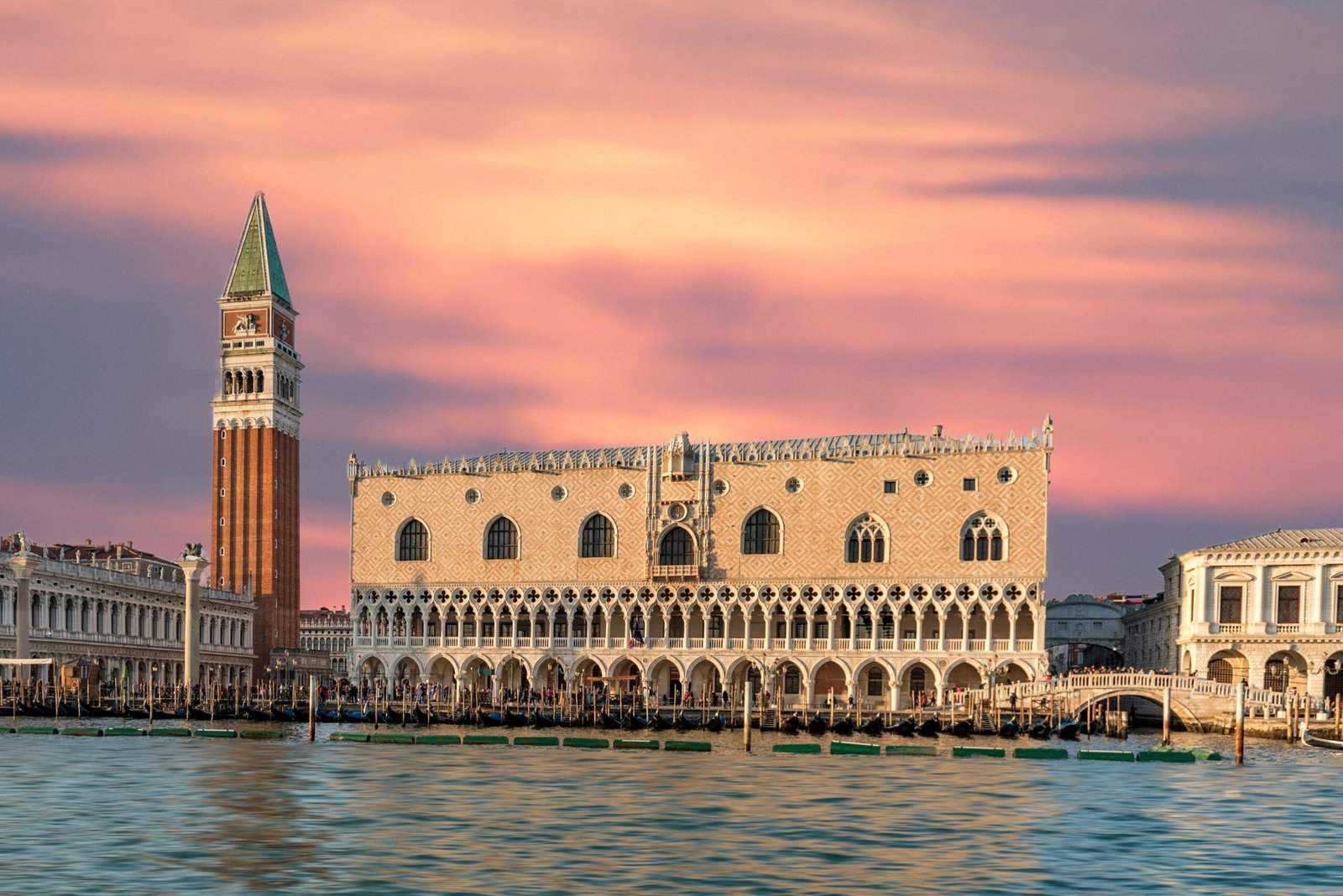 Stunning view of Doge's Palace and St Mark's Campanile during sunset in Venice, Italy.