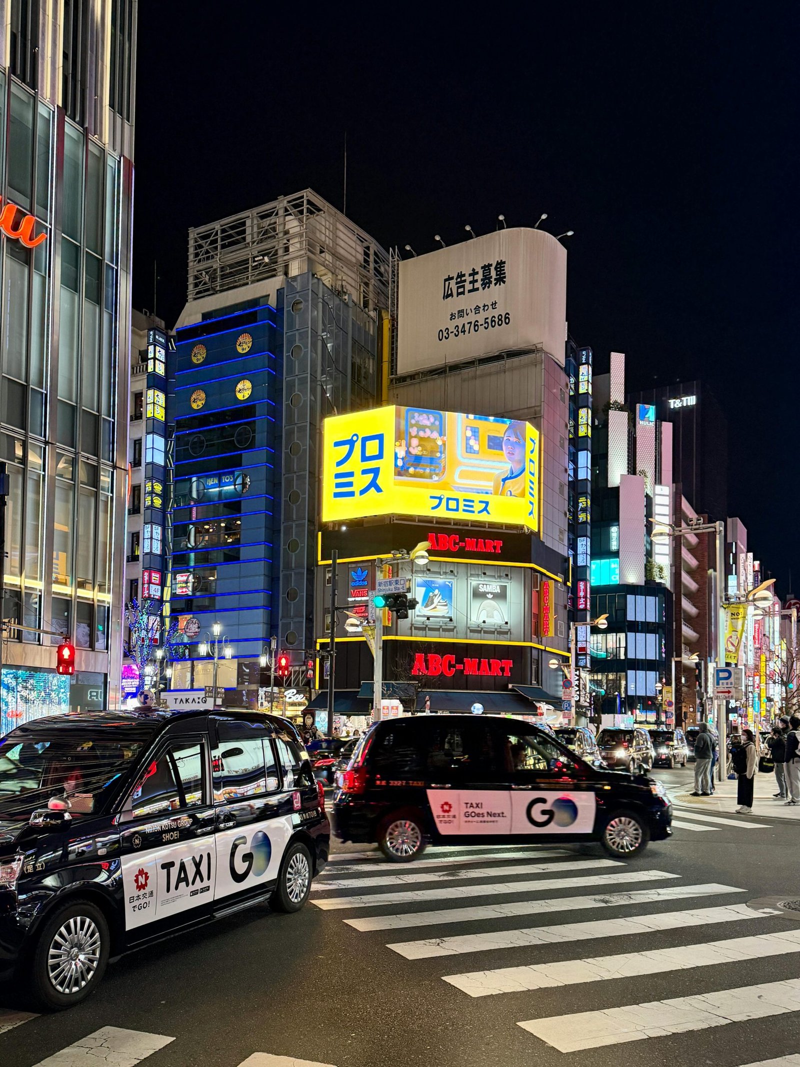 Bright city lights and bustling streets of Shibuya, Tokyo, captured at night.